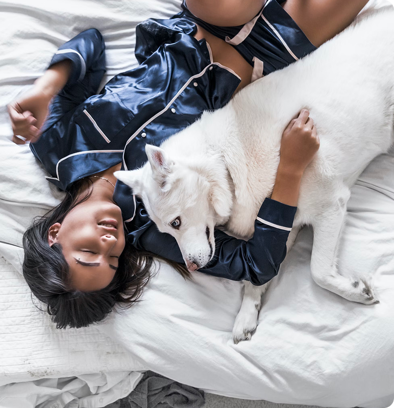 Woman sleeping with her dog